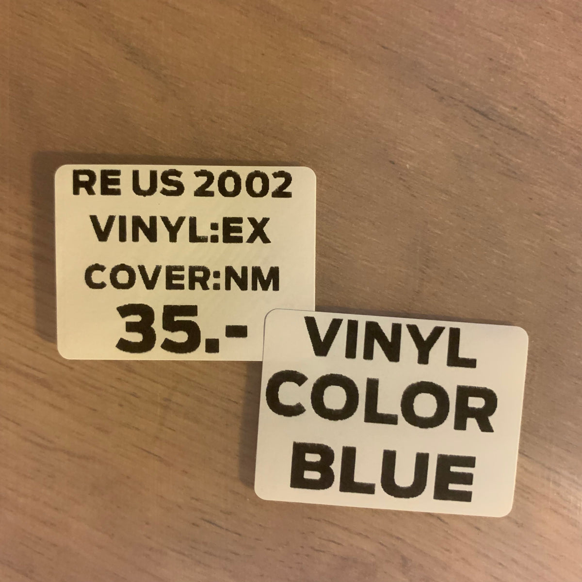Étiquette état RE US 2002 EX NM vinyle bleu 35 CHF